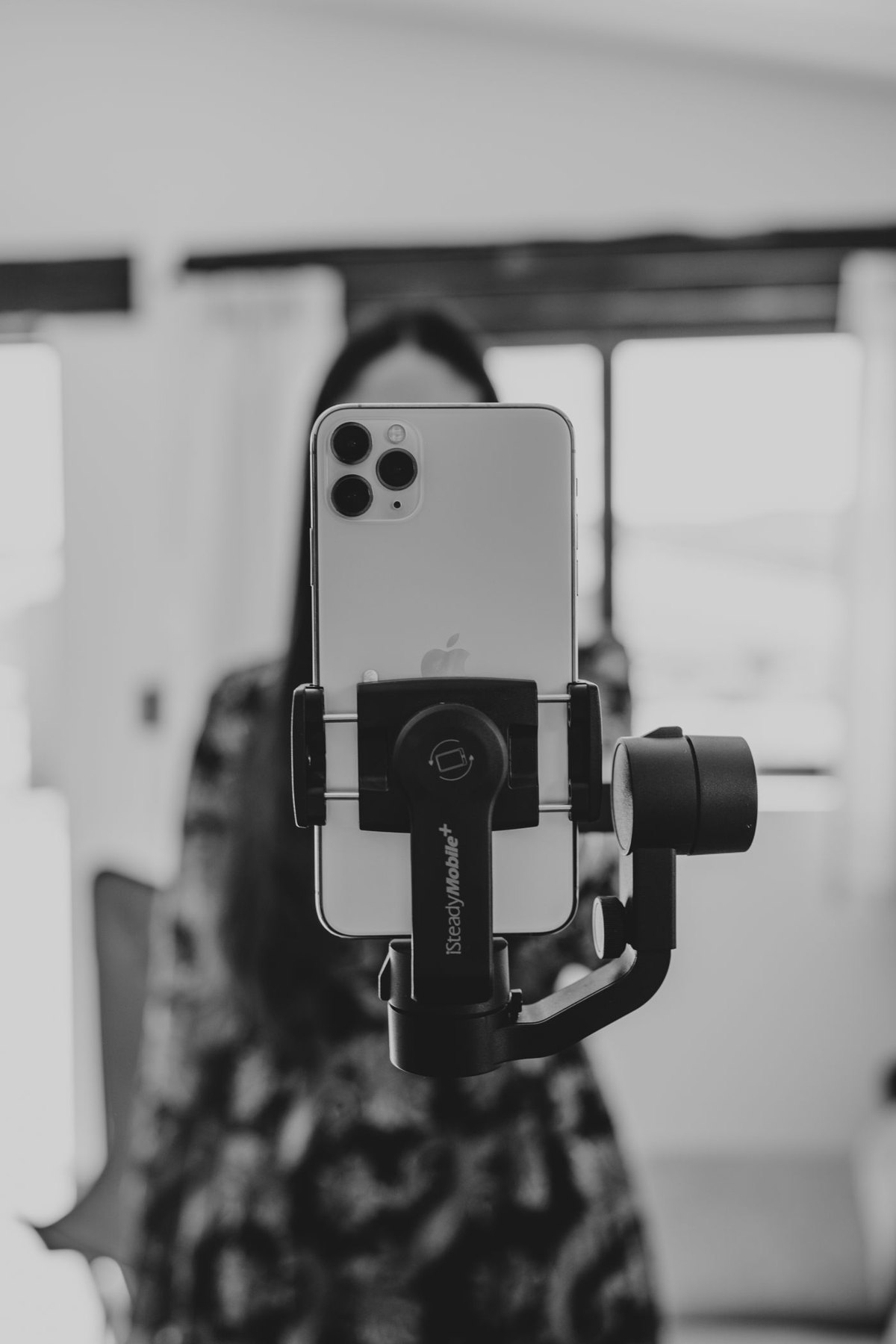 Phone mounted on a handheld filming support