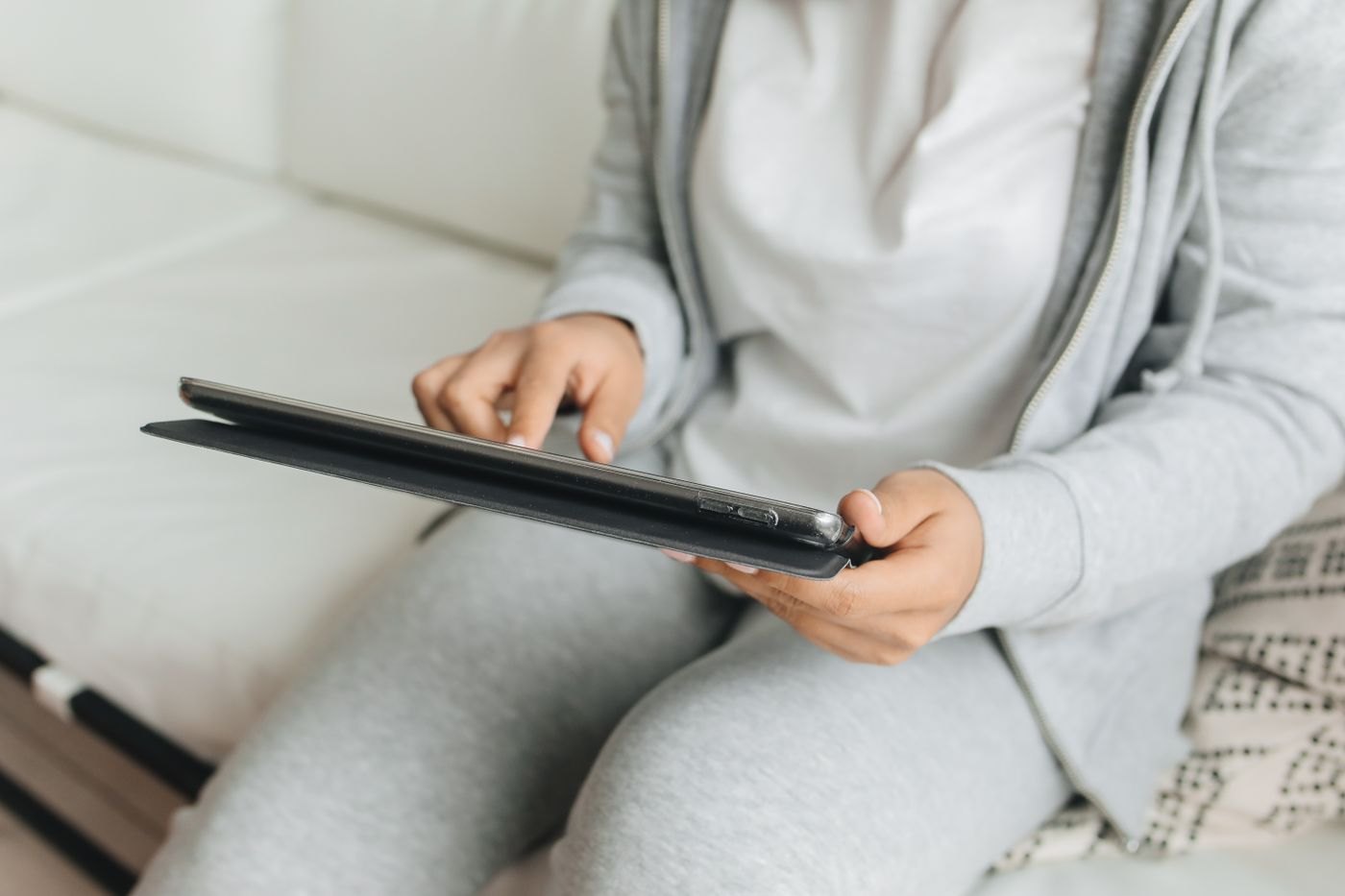Person tapping a tablet at home