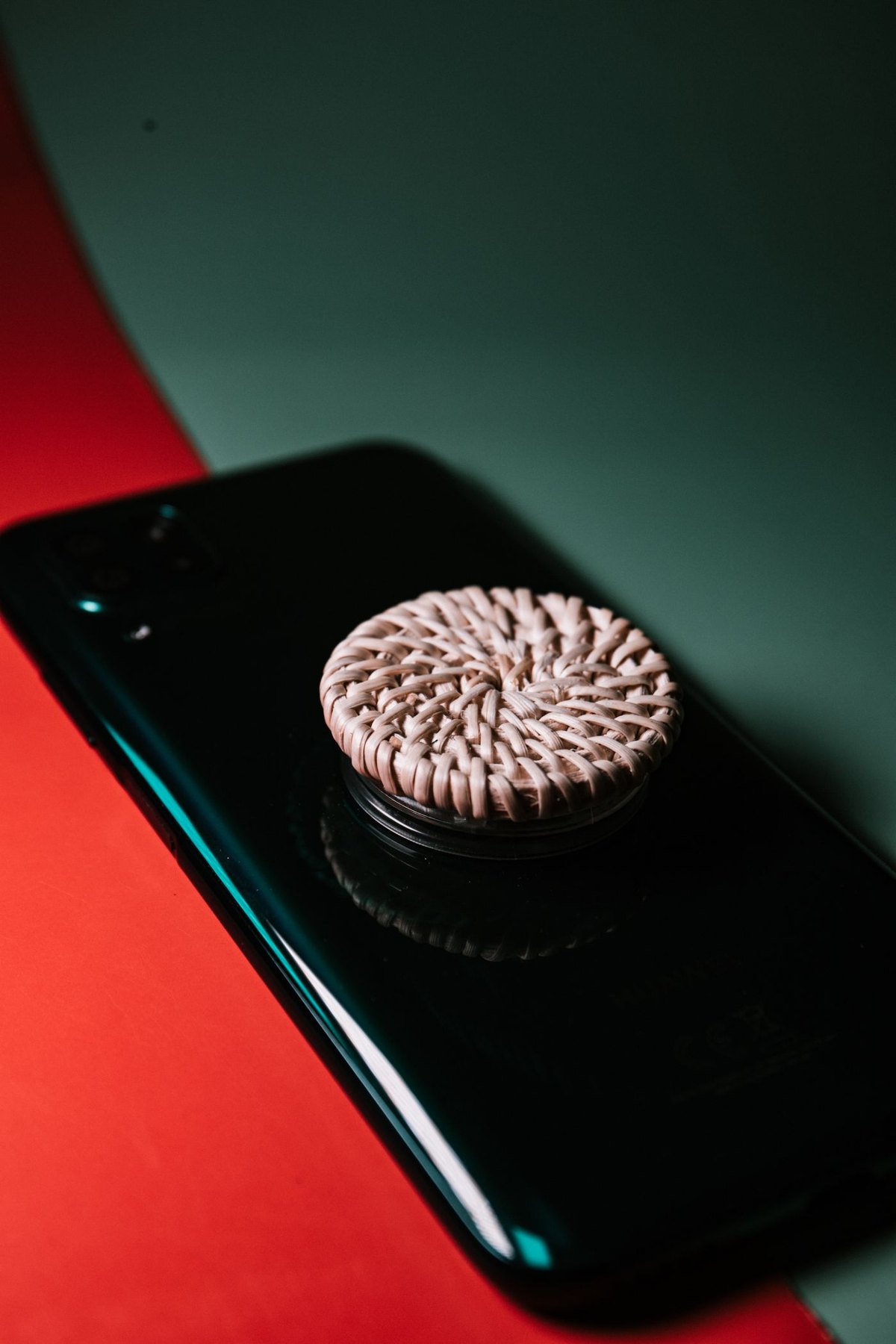 Textured circular grip attached to a black phone case