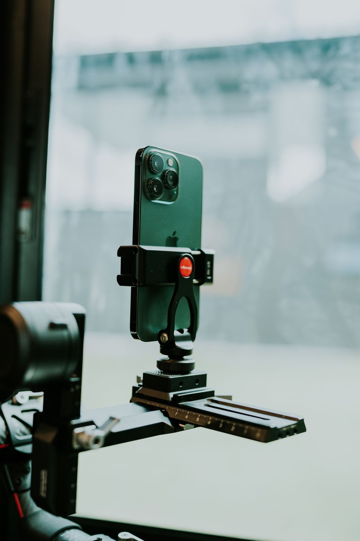 Phone mounted on a filming rig with hand grips