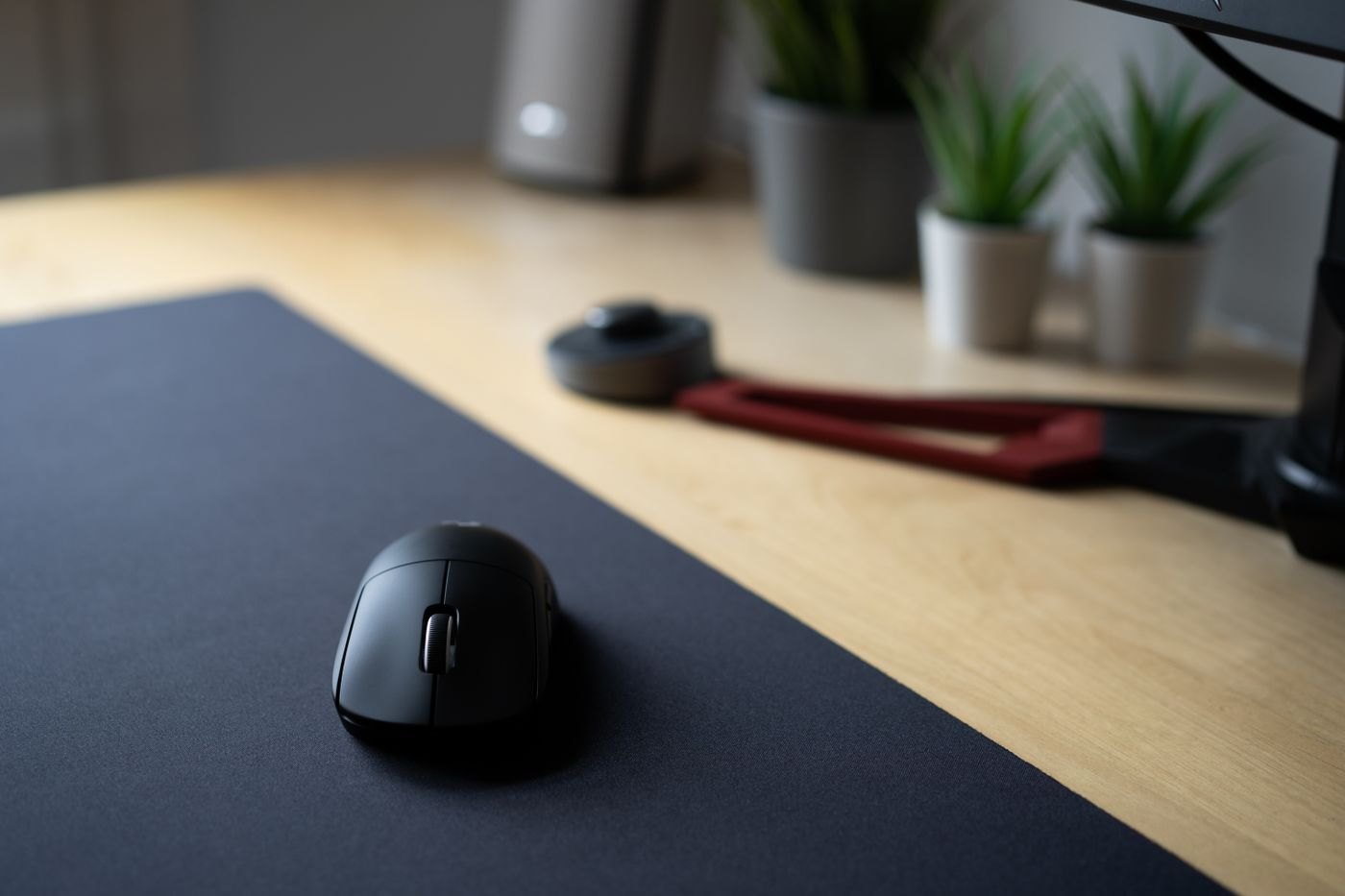 Wireless mouse on a black desk mat
