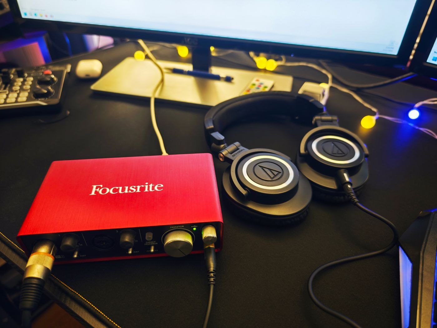Audio interface and headphones in a recording workspace