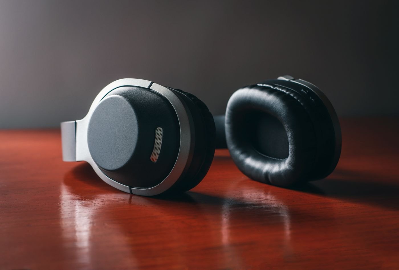 Over-ear headphones resting on a wooden surface