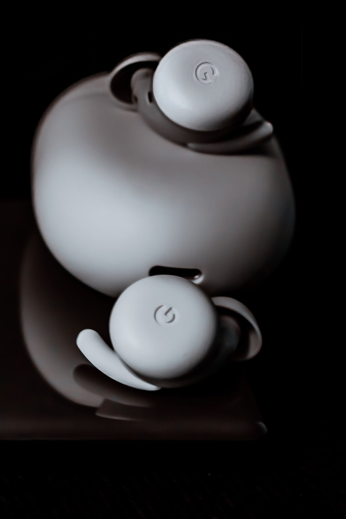 Wireless earbuds seated in their charging case