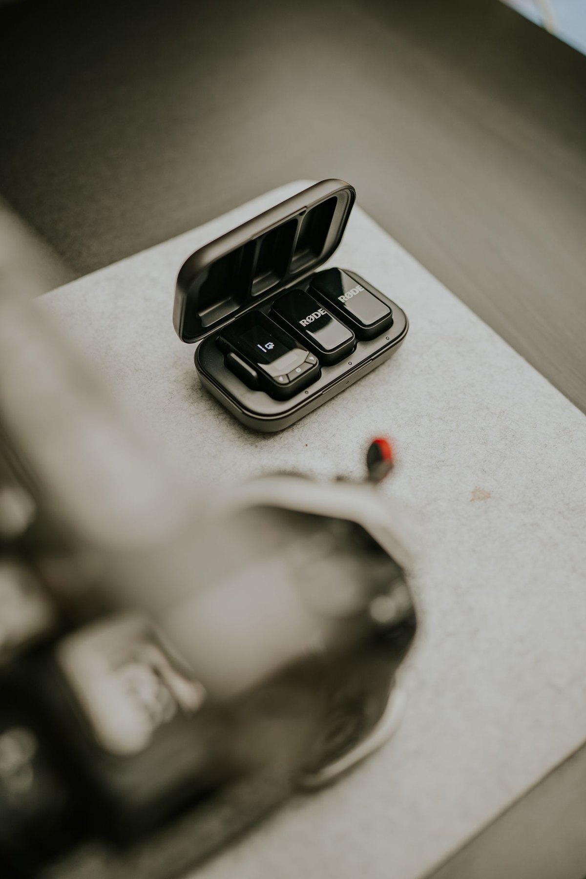 Small wireless microphones in an open charging case