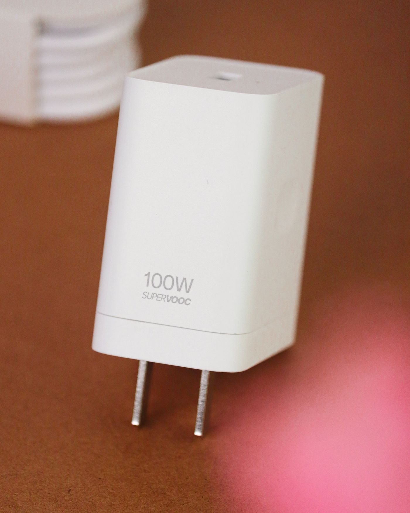 White laptop power adapter on a wooden surface