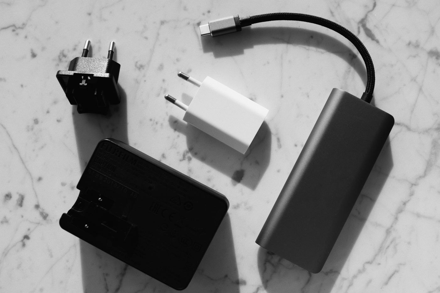 Power adapters with different plug shapes on a table