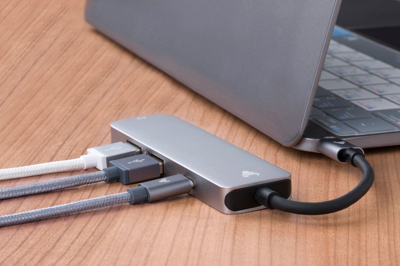 Multiport adapter and several cables connected to a laptop
