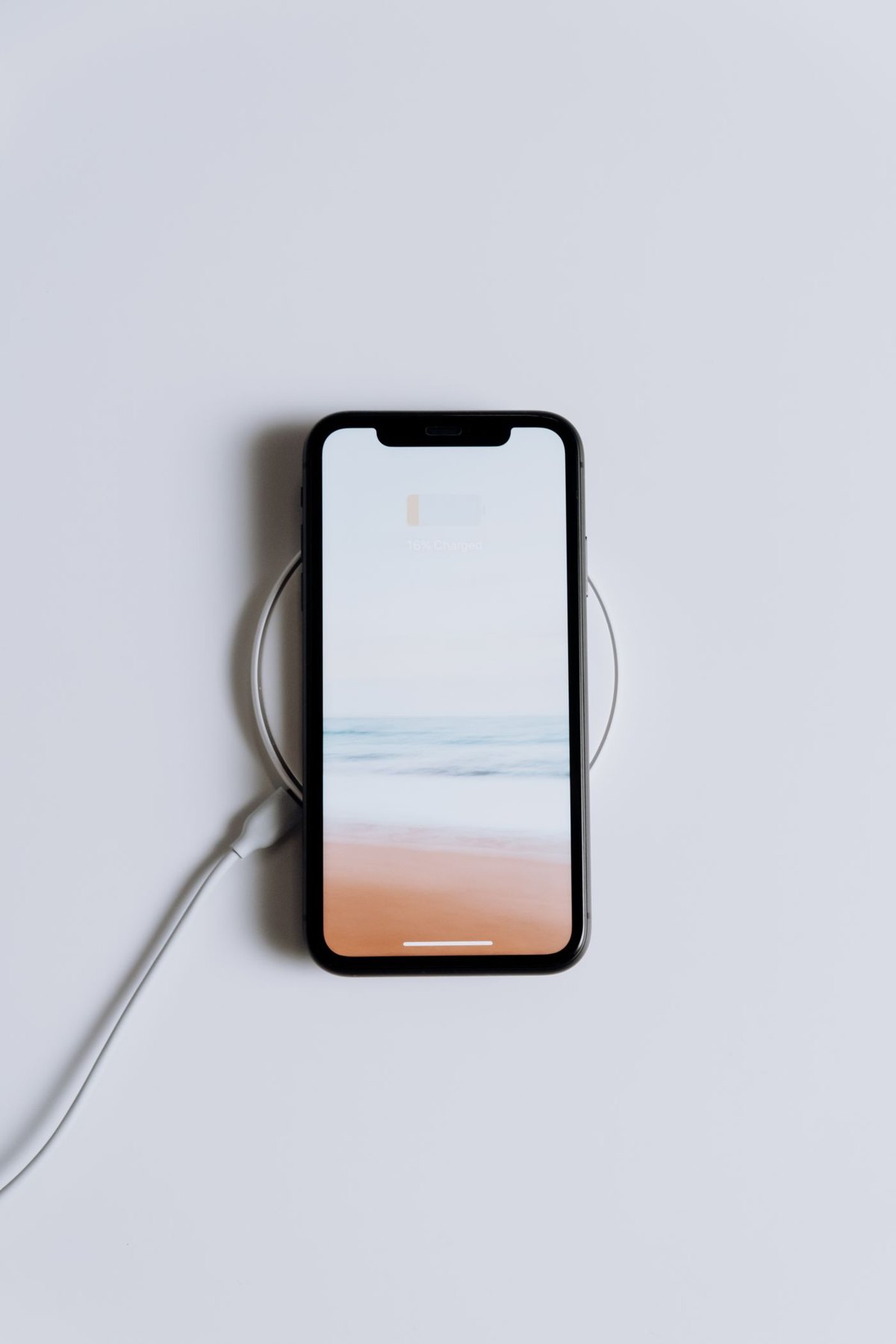 Phone resting on a circular charging pad