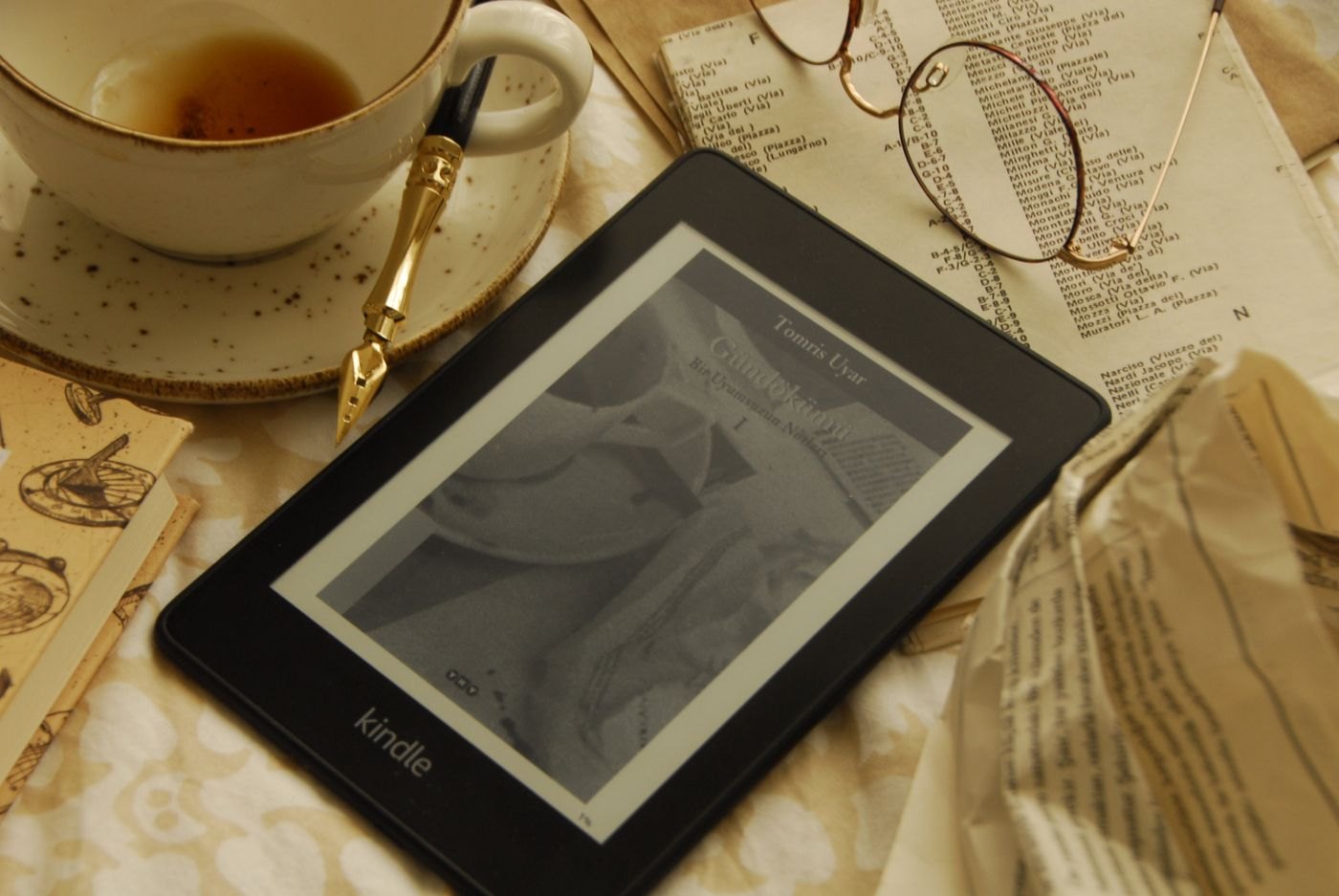 Digital reading device beside an open printed book