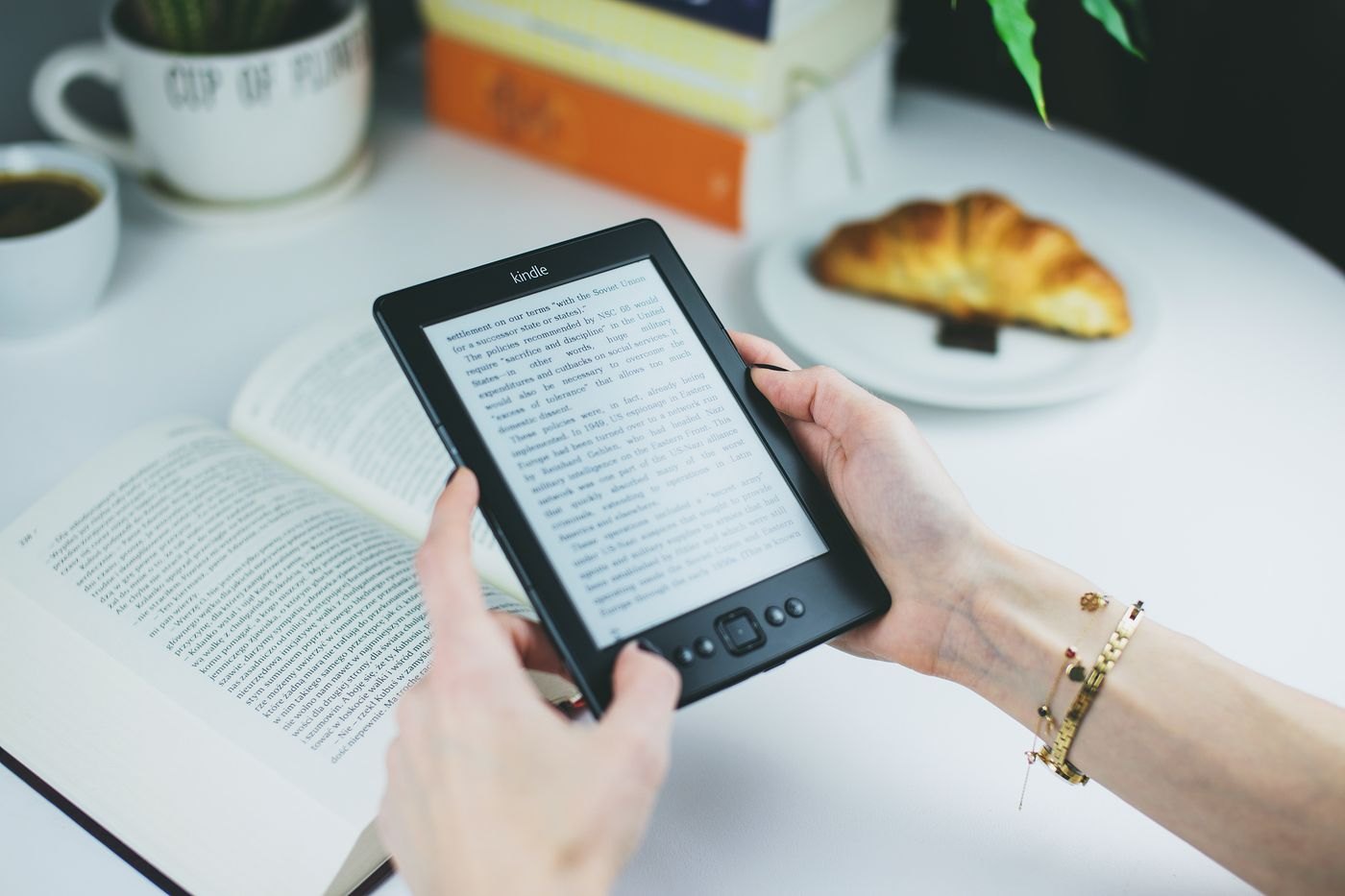 E-reader with physical page controls held at a table